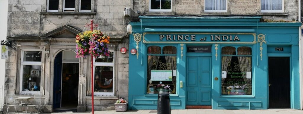 Shop fronts on Peebles High Street, Scottish Borders, including the Prince of India